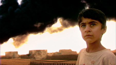 A Kurdish boy, with brick-making ovens in the background
Photo: Typecasting Releasing