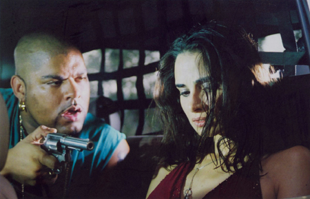 Budu (Pedro Perez) threatens Carla (Mia Maestro)
Photo: Miramax